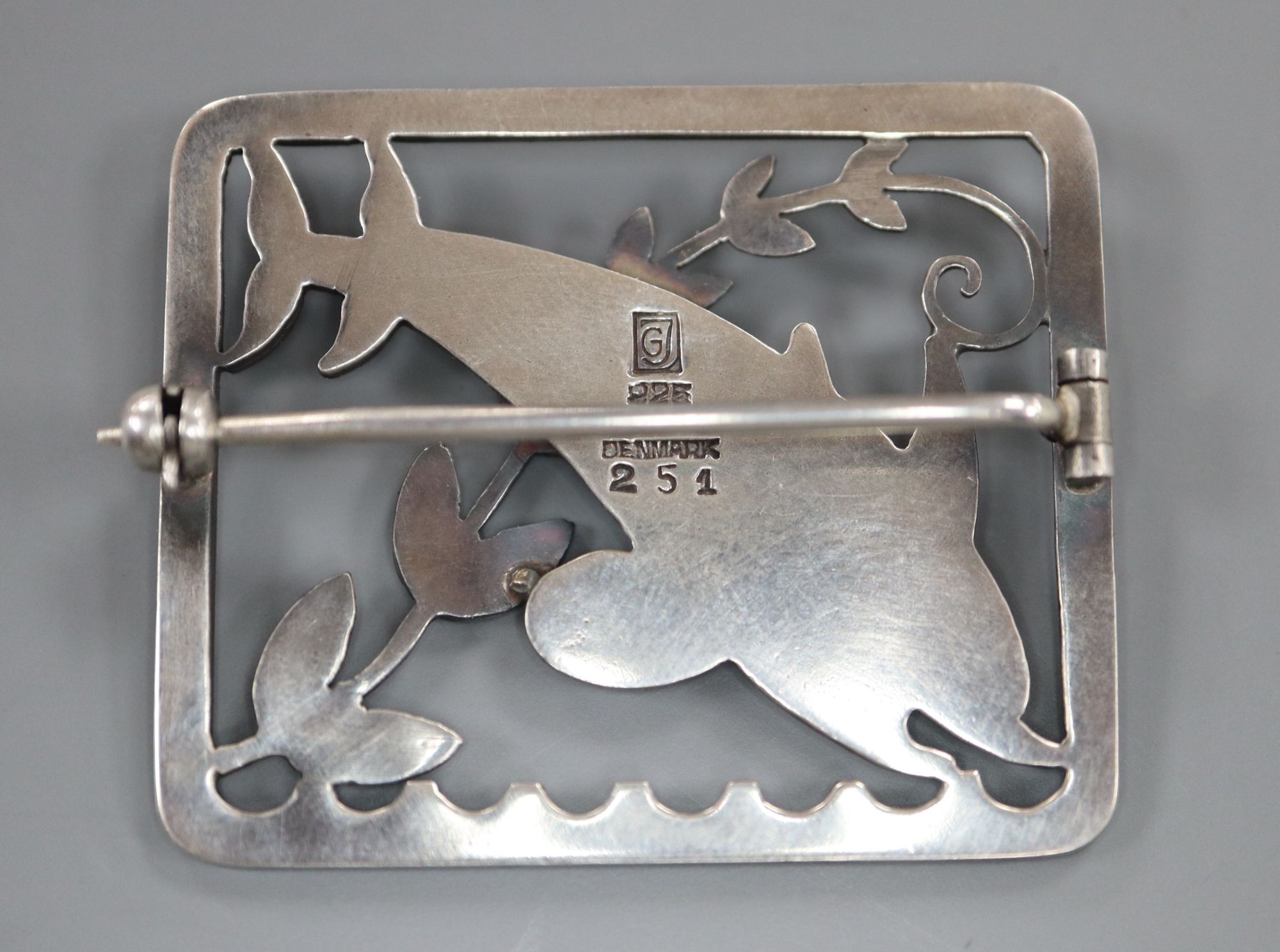 A George Jensen sterling twin dolphin square brooch, designed by Arno Malinowski, no. 255, 37mm.